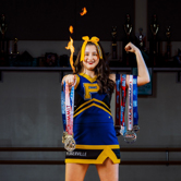 Pflugerville Cheer athlete with medals and flames
